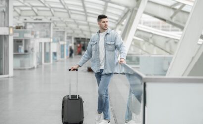 male-passenger-with-travel-suitcase-waiting-for-fl-2023-04-20-20-51-02-utc-min